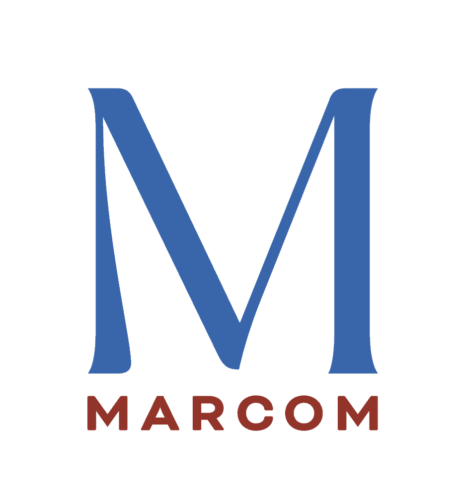 A large blue letter "M" is displayed prominently with the word "MARCOM" written in bold, red letters below it. The background is black.